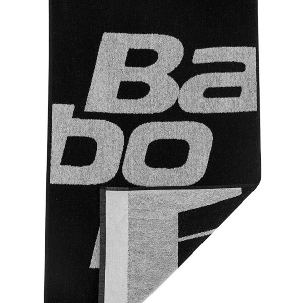 Black and white image of a professional player holding a racquet and preparing to serve in a tennis match