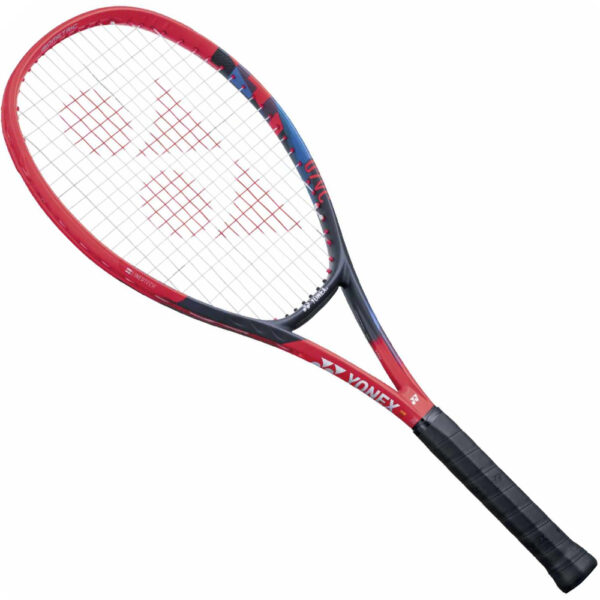 A close-up image of a tennis racquet with a black grip and strings, against a blurred background.